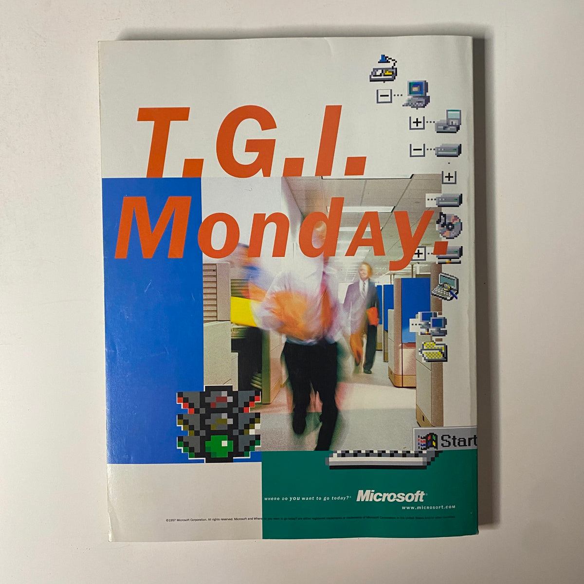 Cover image of a Microsoft advertisement titled 'T.G.I. Monday,' highlighting a busy office environment with computer graphics, reflecting the tech culture of the late 1990s.