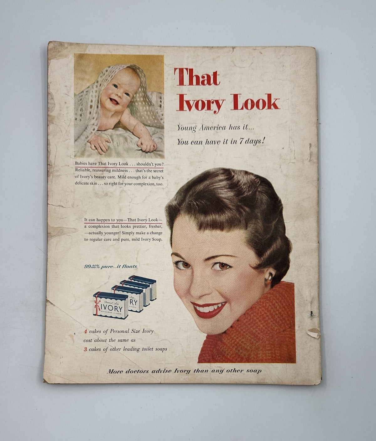 Photoplay Magazine October 1954 featuring an advertisement for Ivory Soap, showcasing a smiling woman and a baby, highlighting the tagline 'That Ivory Look'.