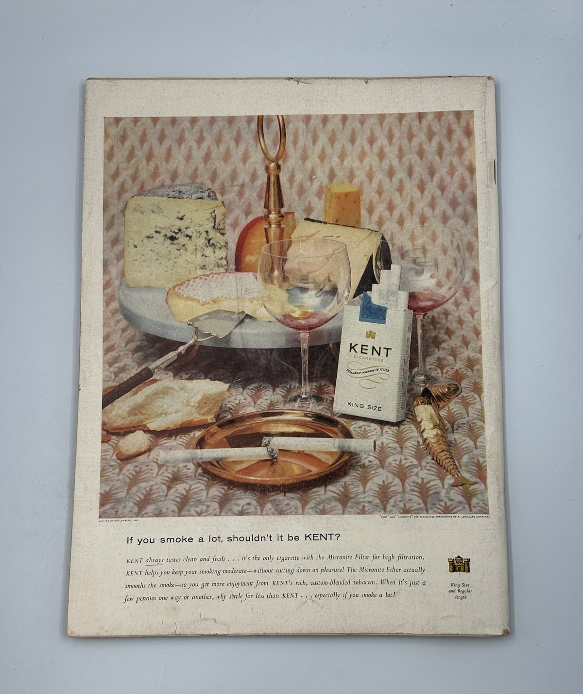 Back cover of Life Magazine, April 23, 1956 with an advertisement for Kent cigarettes featuring a still life arrangement of cheese, wine, and a corkscrew, showcasing the magazine's vintage marketing aesthetics.
