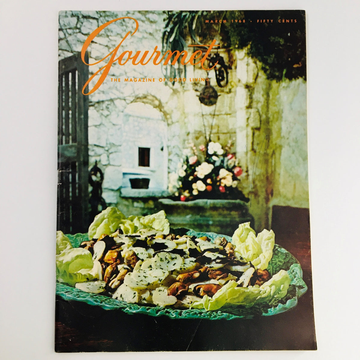 Gourmet Magazine of Good Living March 1968 cover featuring a vibrant dish of salad with an elegant presentation, set against a rustic backdrop with floral elements.