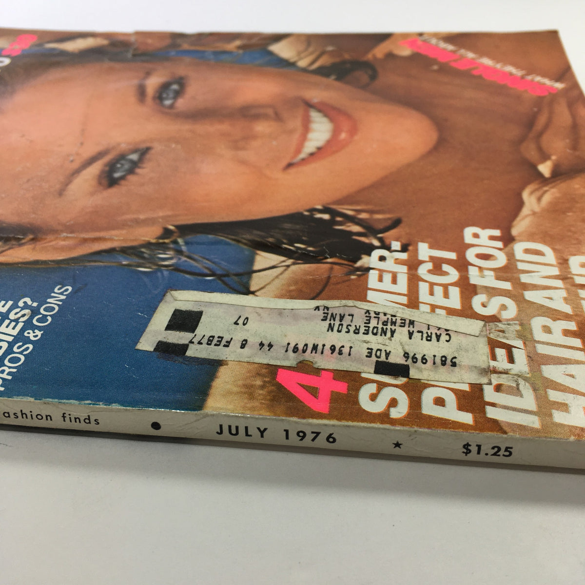Close-up side view of the July 1976 Glamour Magazine cover, highlighting the magazine's title and summer fashion tips, ideal for enthusiasts of retro fashion.