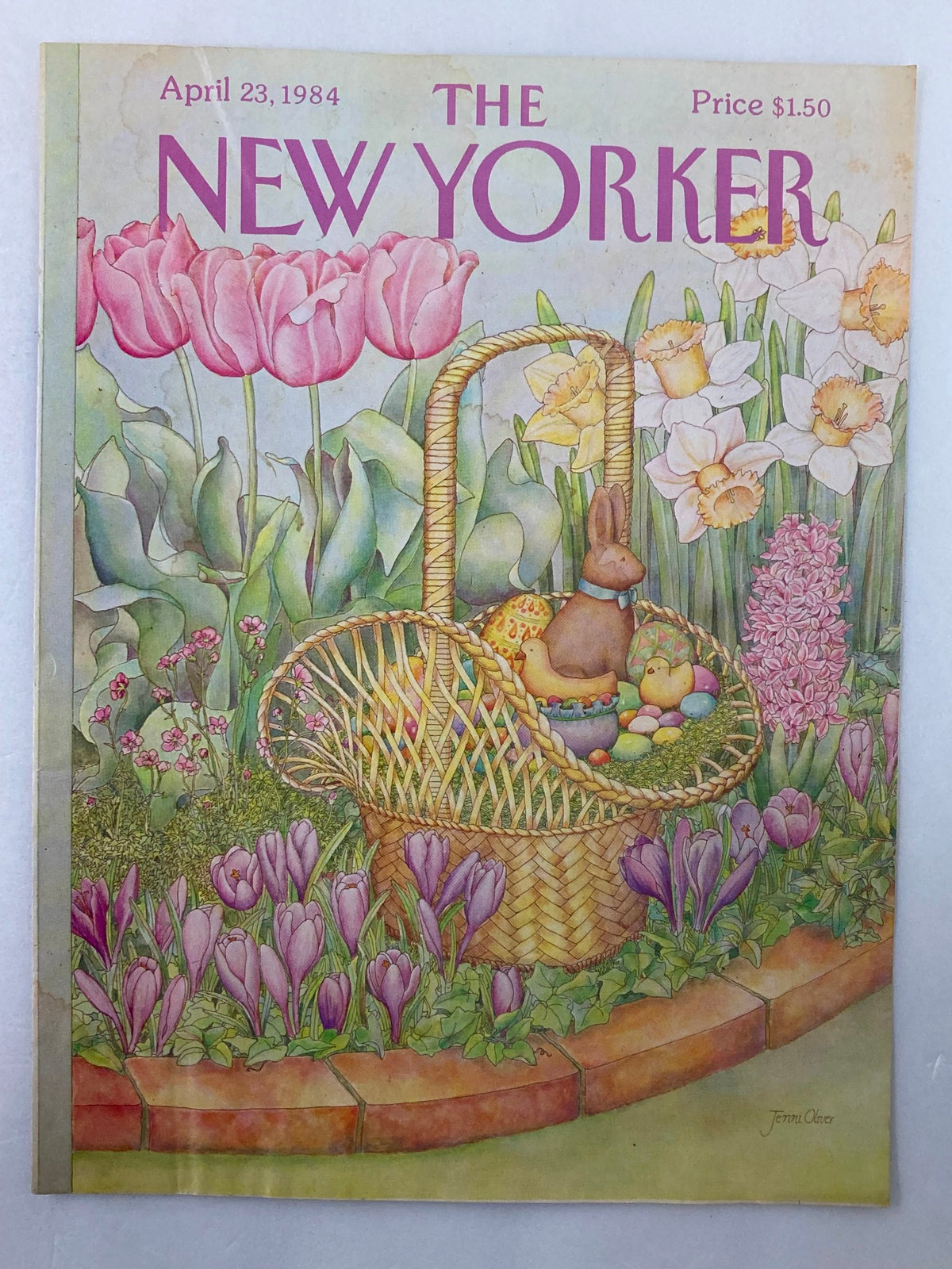 Cover of The New Yorker, April 23, 1984, showcasing an Easter Bunny illustration by Jenni Oliver, highlighting a basket filled with eggs and floral details in a springtime setting.