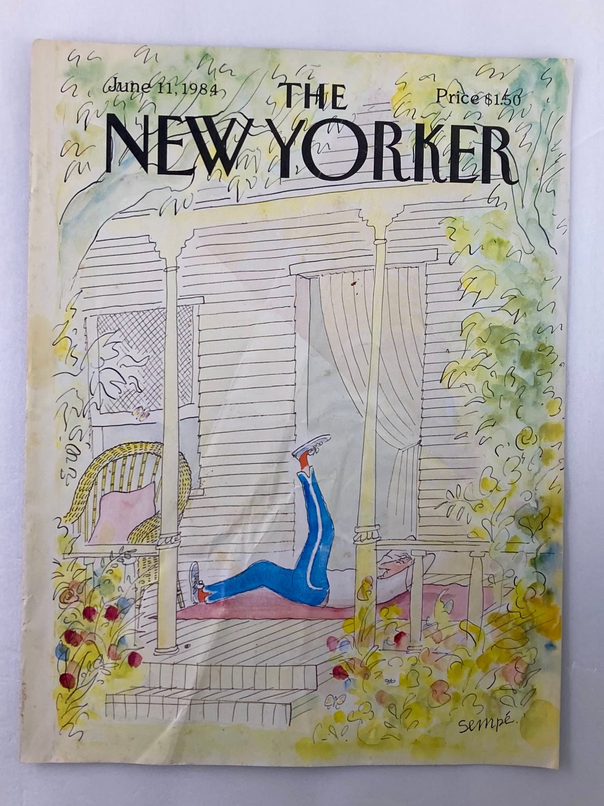 Cover only of The New Yorker dated June 11, 1984, displaying the artwork "Warming Up" by J. J. Sempe, depicting a relaxed scene on a porch, surrounded by lush greenery.