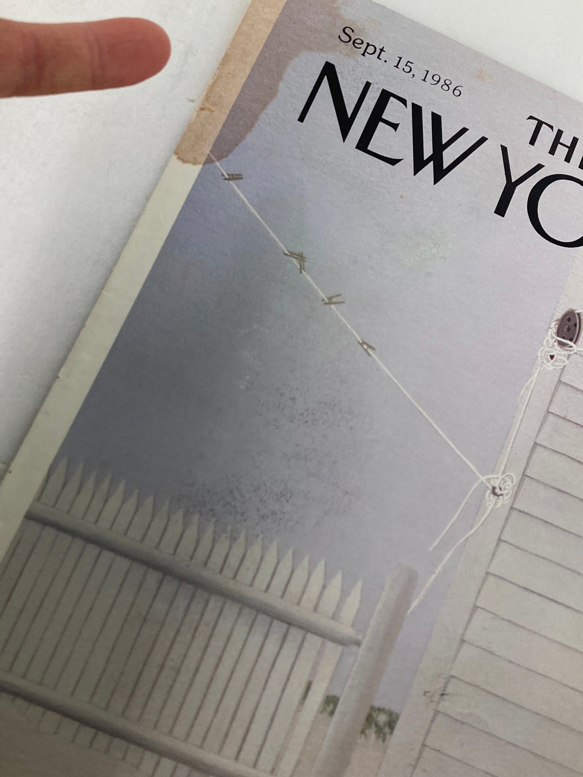 Close-up view of COVER ONLY The New Yorker September 15 1986 Snowy Day by G. D. Simpson highlighting details of the cover, including the snow-covered fence and hanging clothesline.