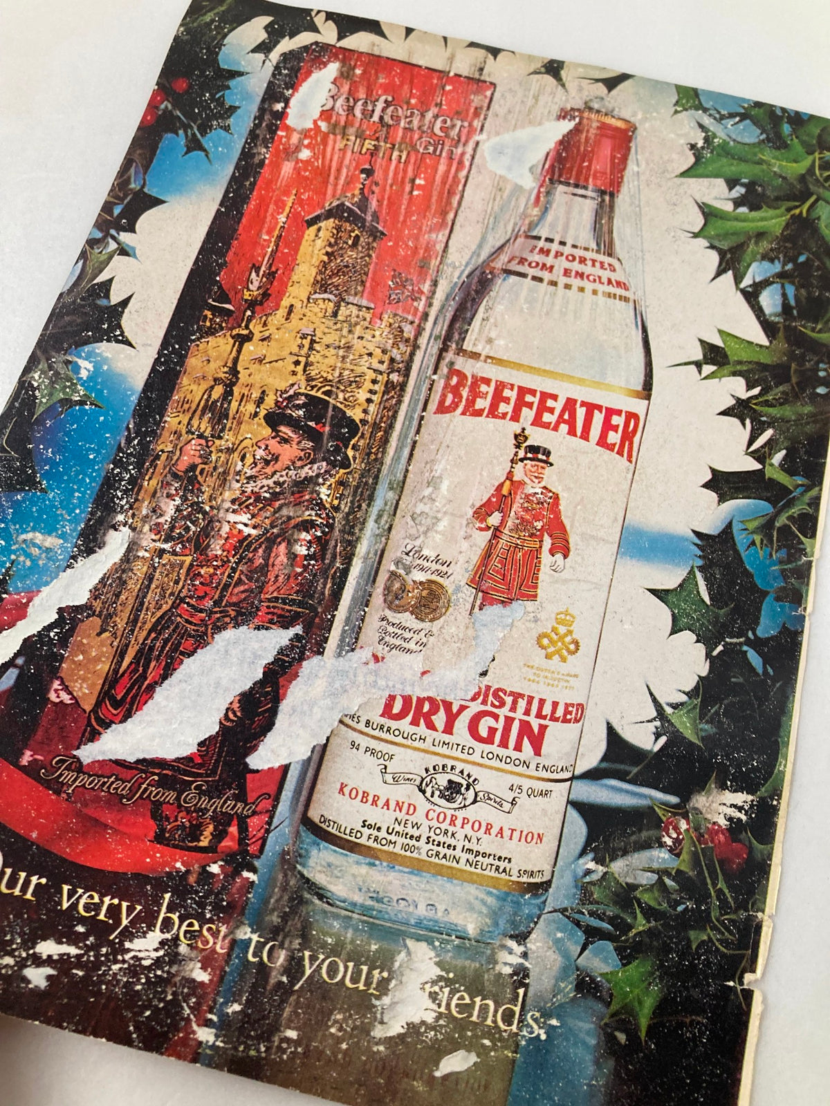Vintage advertisement featuring Beefeater gin bottle graphic art and festive elements, from 1970s era.