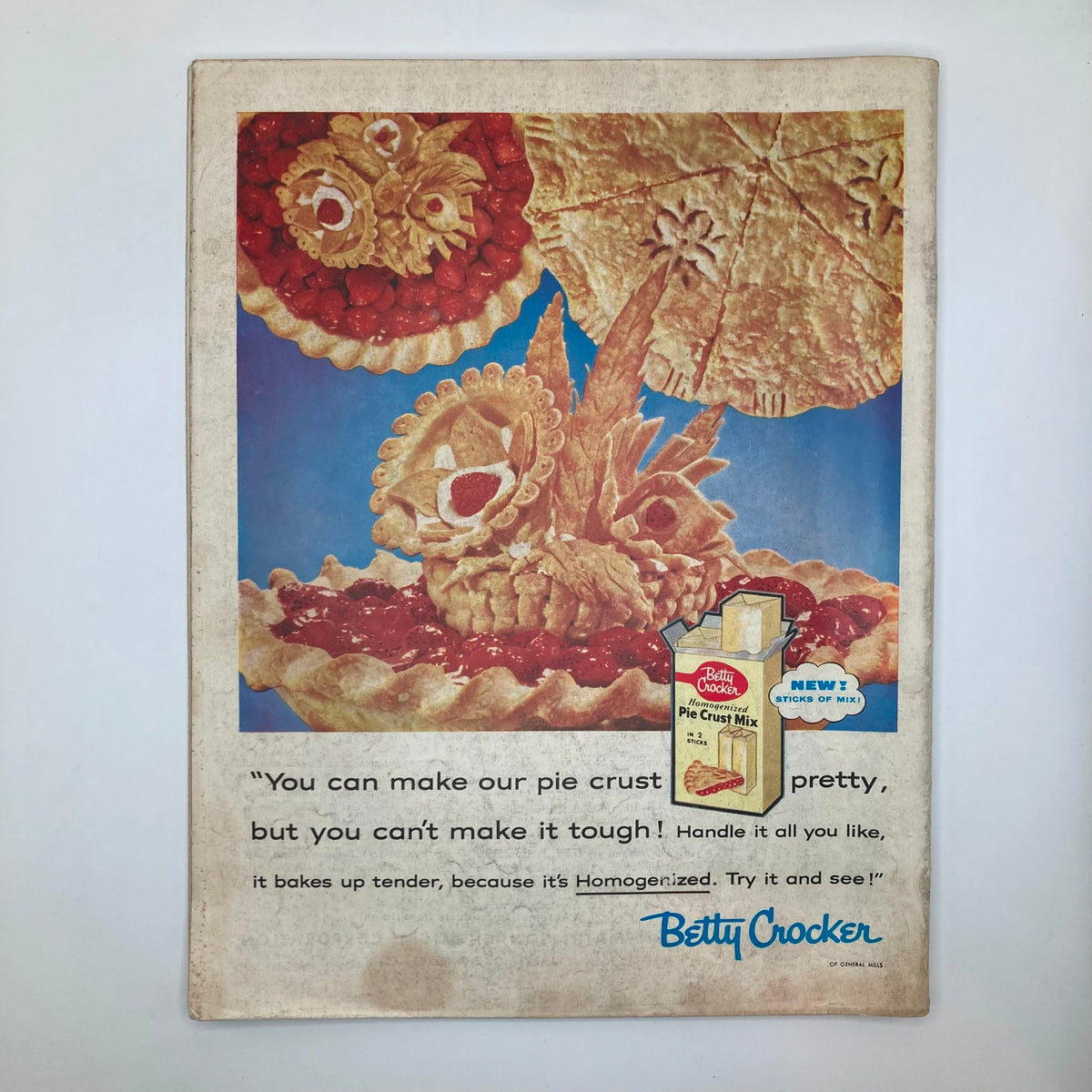 Cover of Betty Crocker Pie Crust Mix advertisement featuring beautifully decorated pies, promoting the convenience of using their product for baking.