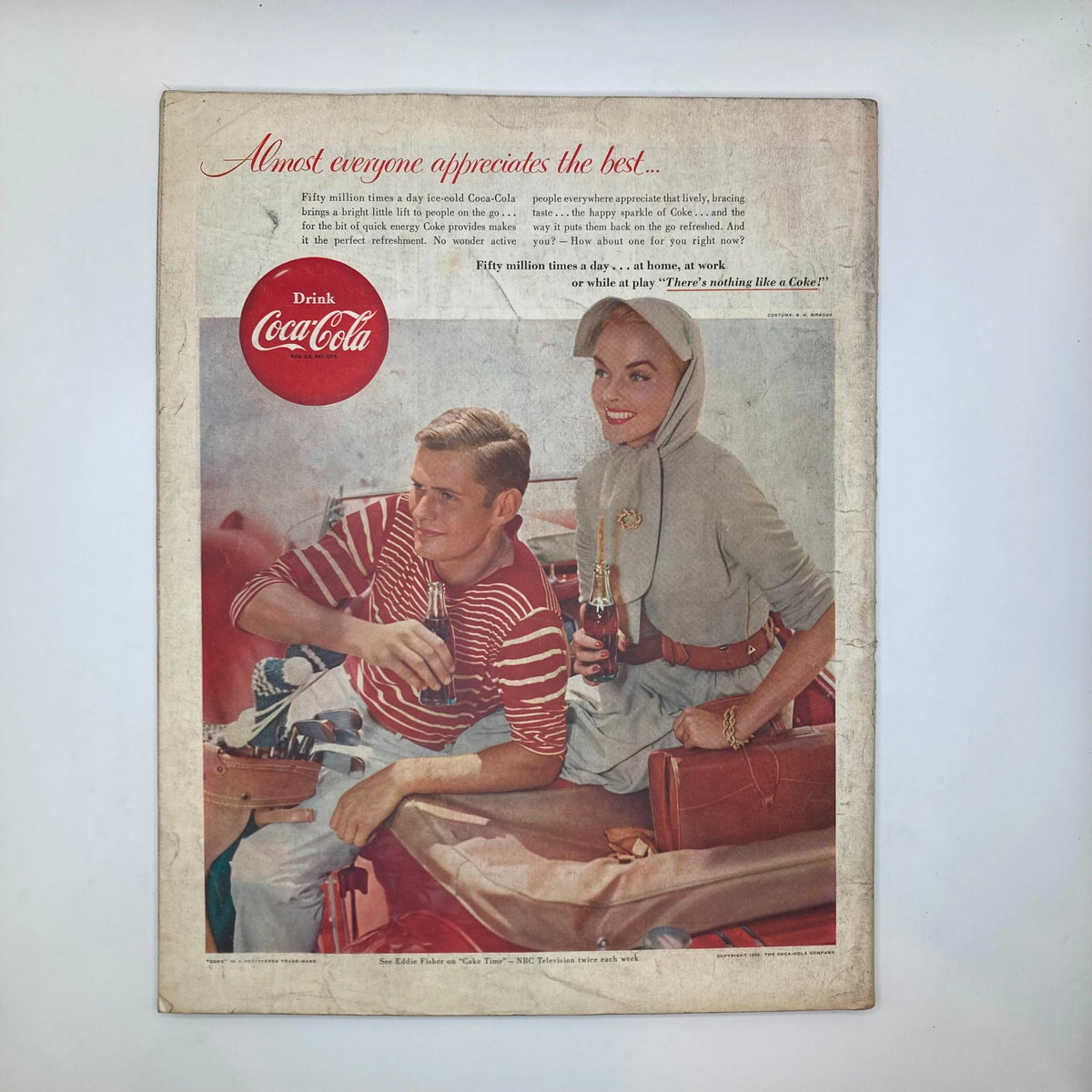 Advertisement in the Saturday Evening Post Magazine dated May 14, 1955, promoting Coca-Cola with a catchy slogan, featuring a man and a woman enjoying the drink.