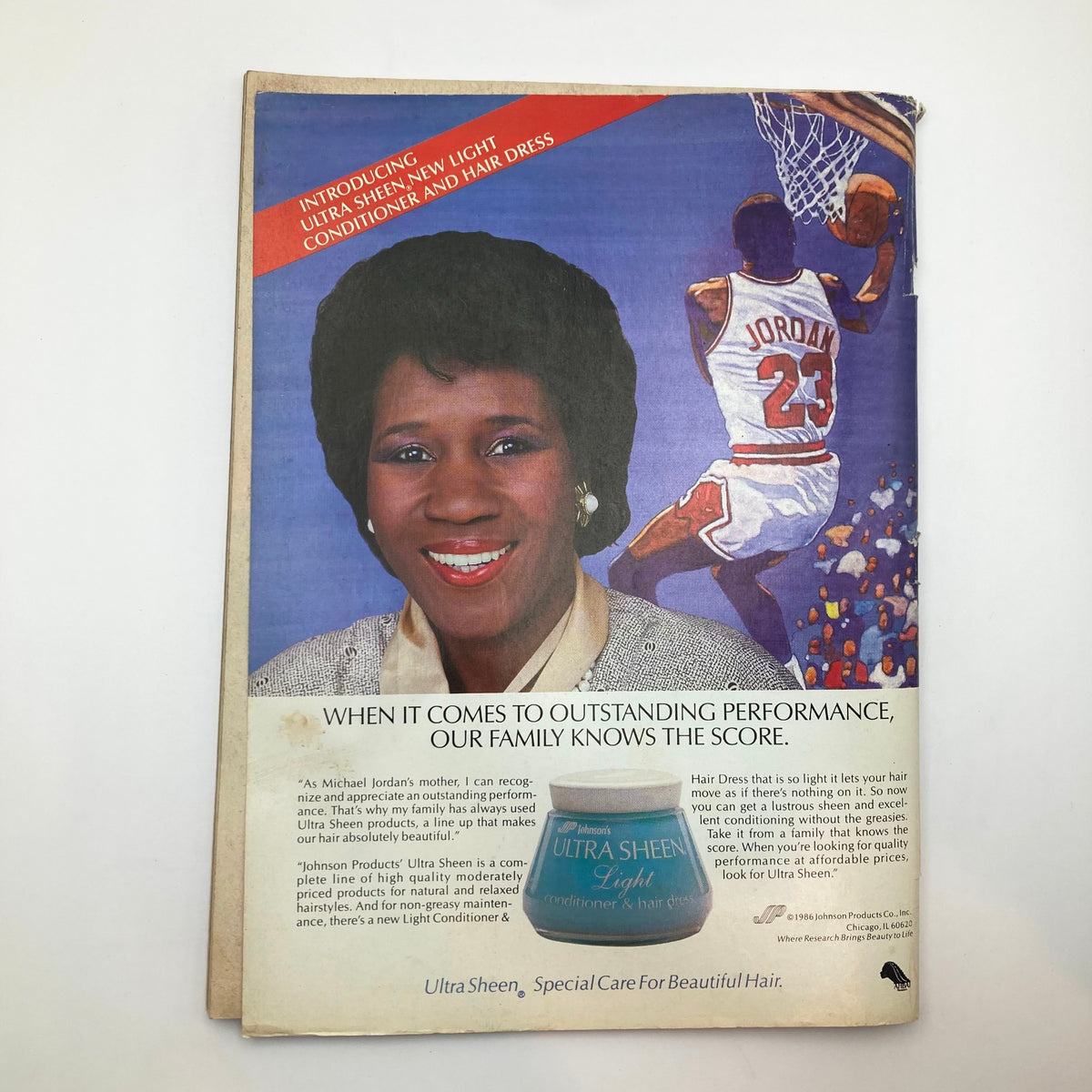 The back cover of Essence Magazine October 1986 featuring an advertisement for Ultra Sheen products, emphasizing hair care in connection to family performance.