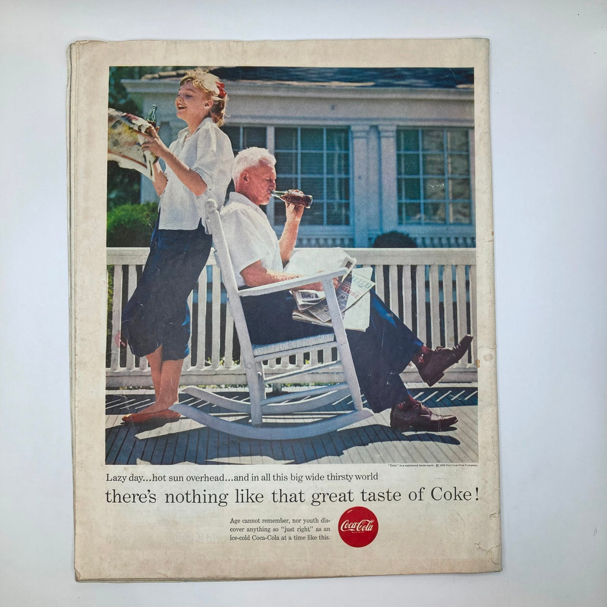 Back cover of Saturday Evening Post Magazine September 1, 1956 featuring a vintage Coca-Cola advertisement with a woman standing and a man sitting on a porch enjoying a drink.