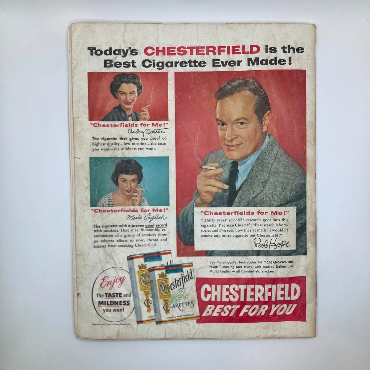 Back cover of the Saturday Evening Post Magazine from June 26, 1954, featuring an advertisement for Chesterfield cigarettes with images of two women and Bob Hope.