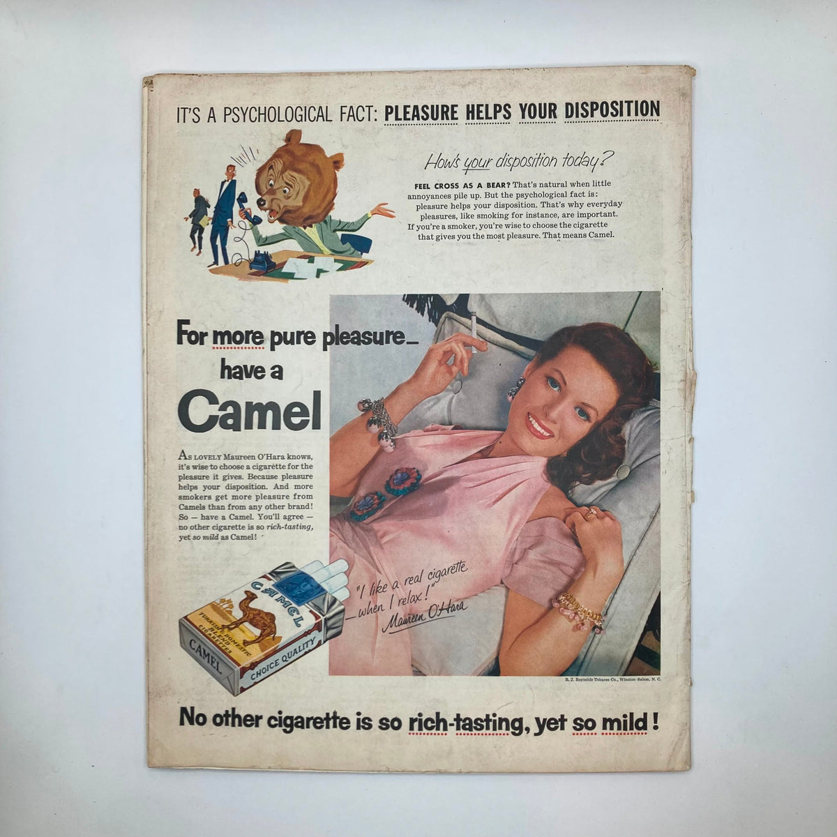Vintage Camel Cigarettes advertisement from Saturday Evening Post Magazine July 23, 1955 featuring a glamorous woman relaxing with a cigarette, highlighting the tagline 'For more pure pleasure... have a Camel' alongside colorful graphics.
