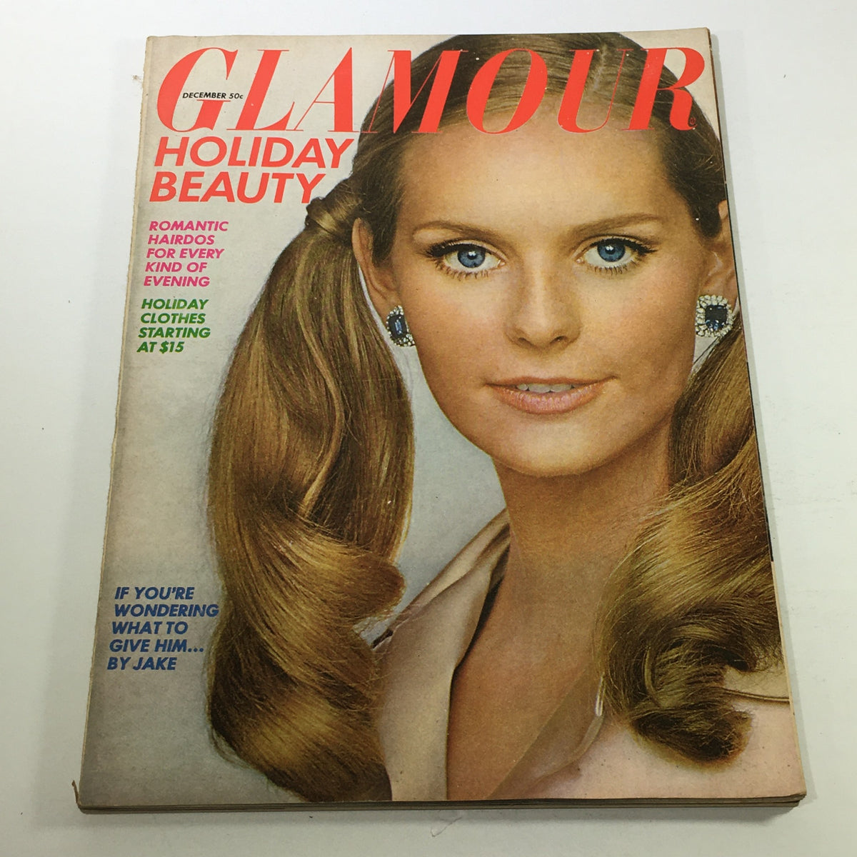 Vintage Glamour Magazine December 1967 cover showcasing holiday beauty and romantic hairdos, featuring a model with long hair and sparkling earrings.