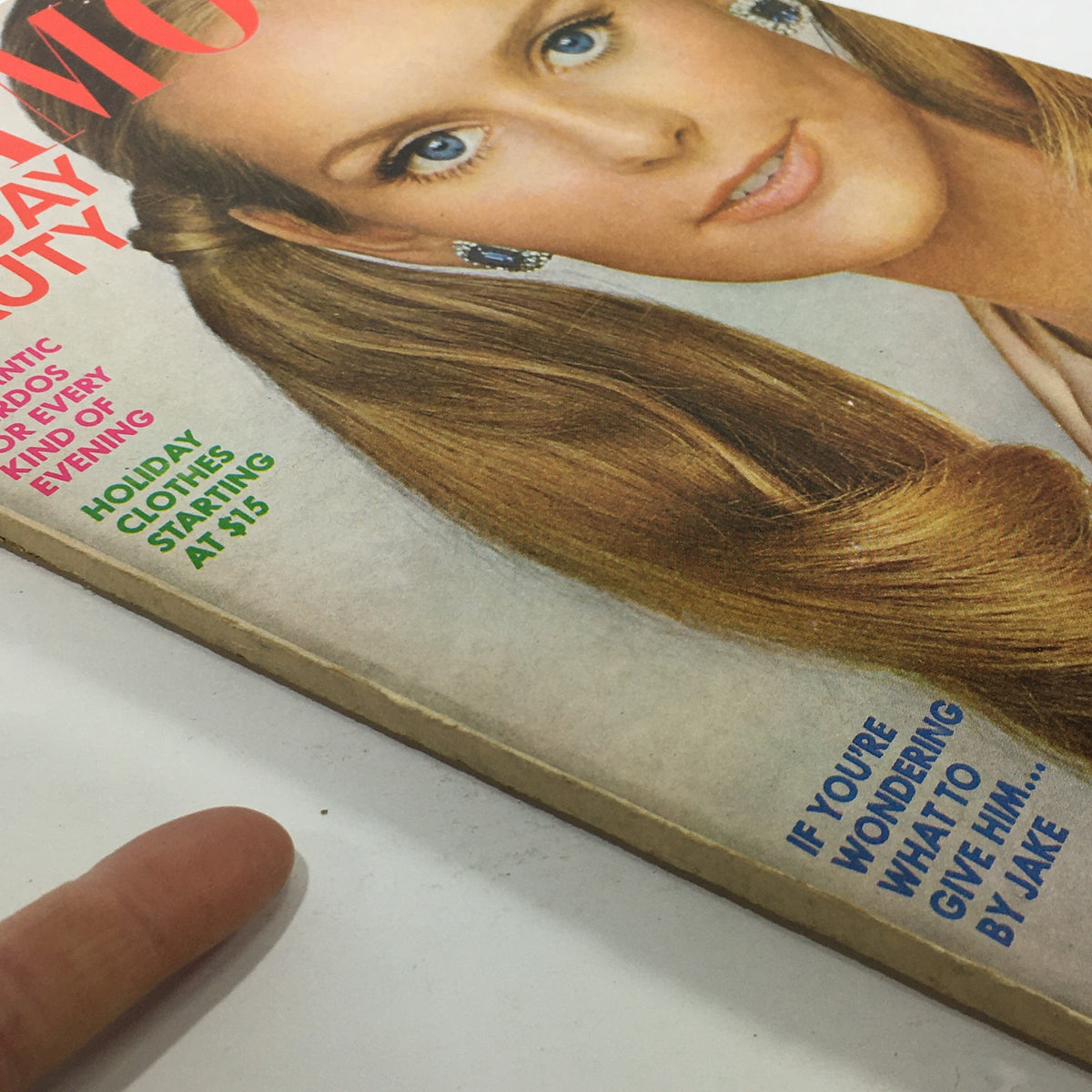Close-up of the Vintage Glamour Magazine December 1967 cover highlighting holiday beauty and romantic hairdos, with text about gift suggestions.