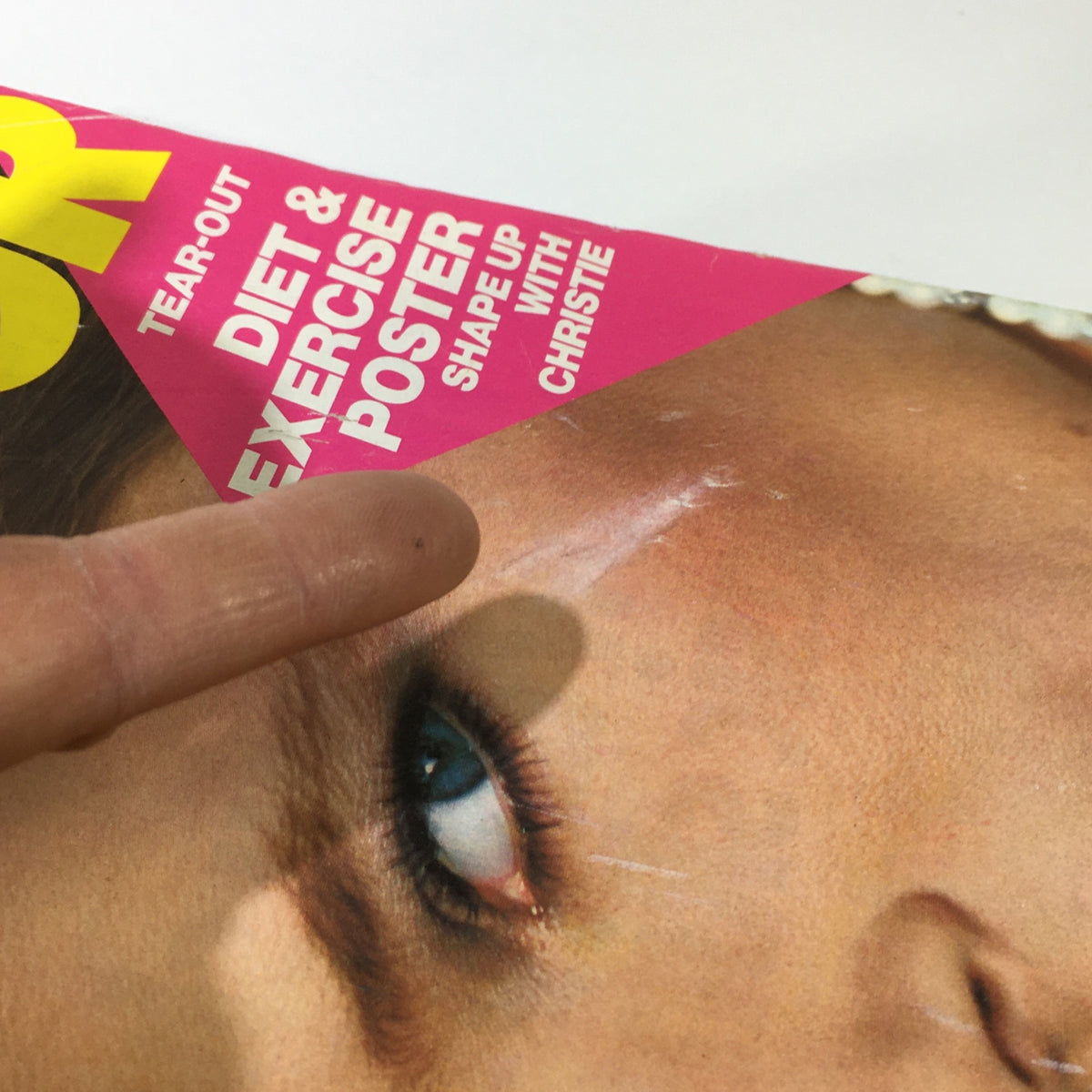 Close-up of the cover of VTG Glamour Magazine: June 1983, highlighting a tear-out poster section and details of Christie Brinkley's iconic look.