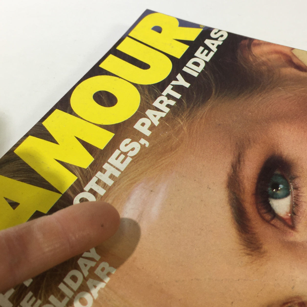 Close-up of the cover of VTG Glamour Magazine December 1980, highlighting the facial features of Kim Alexis and visible details of the magazine's condition.
