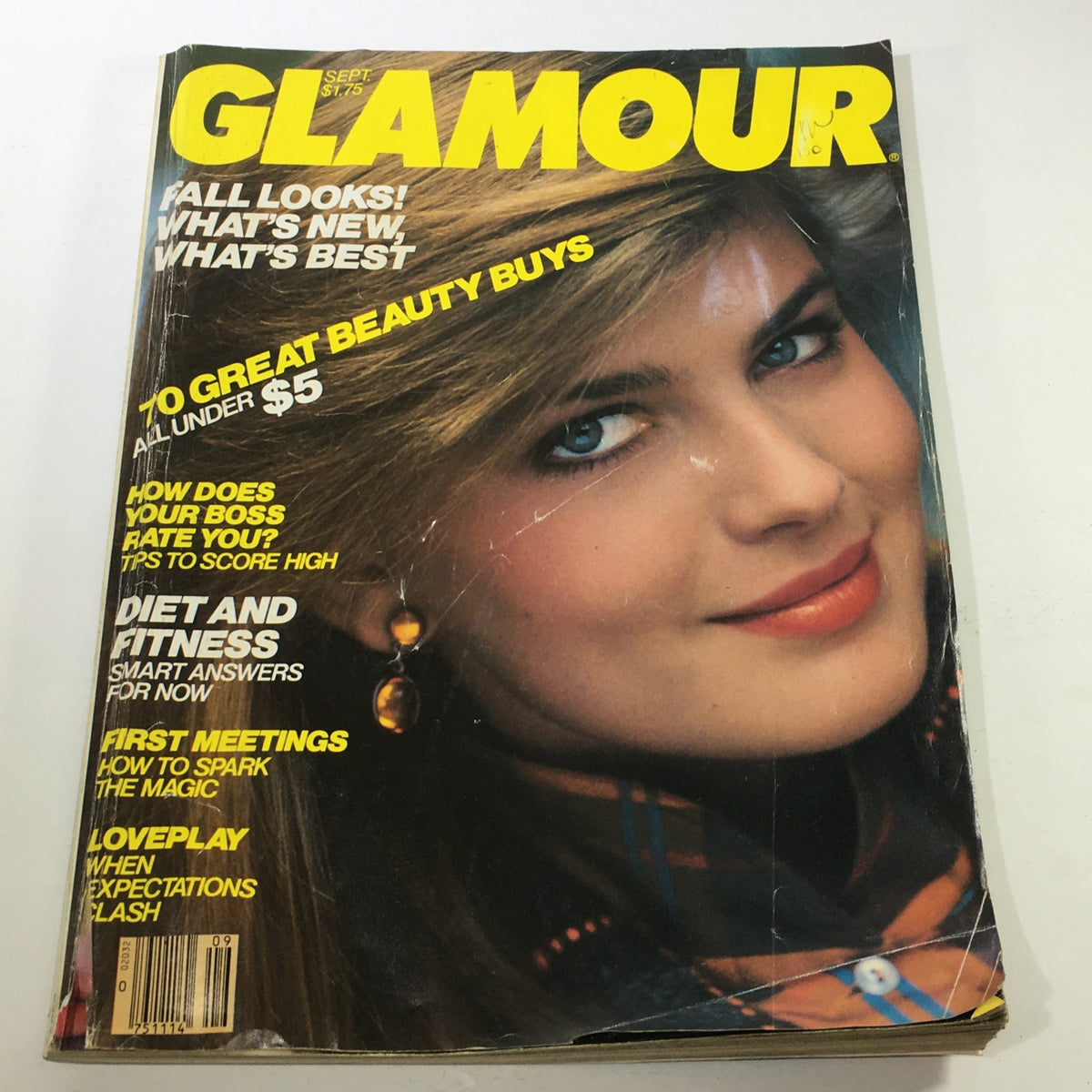 VTG Glamour Magazine September 1982 cover featuring a close-up image of Paulina Porizkova, showcasing her iconic 80s hairstyle and makeup, with a bright yellow title. This collectible issue emphasizes fashion trends from the 1980s.