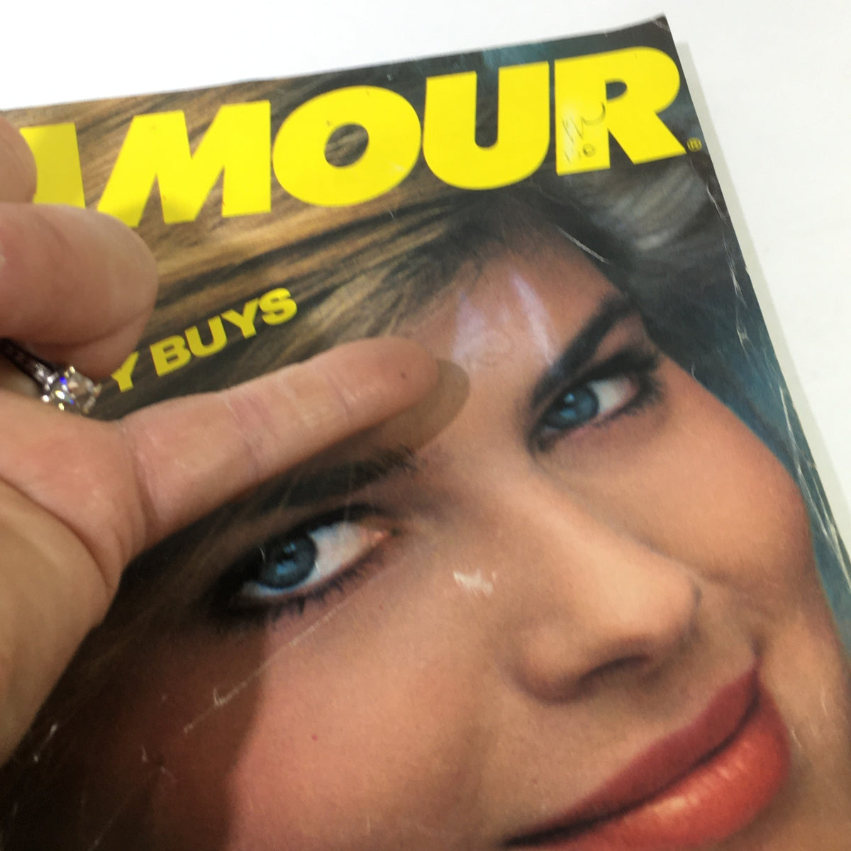 Detail of VTG Glamour Magazine September 1982, highlighting Paulina Porizkova's face on the cover, with a focus on her striking blue eyes and makeup, underscoring the magazine's vintage charm.