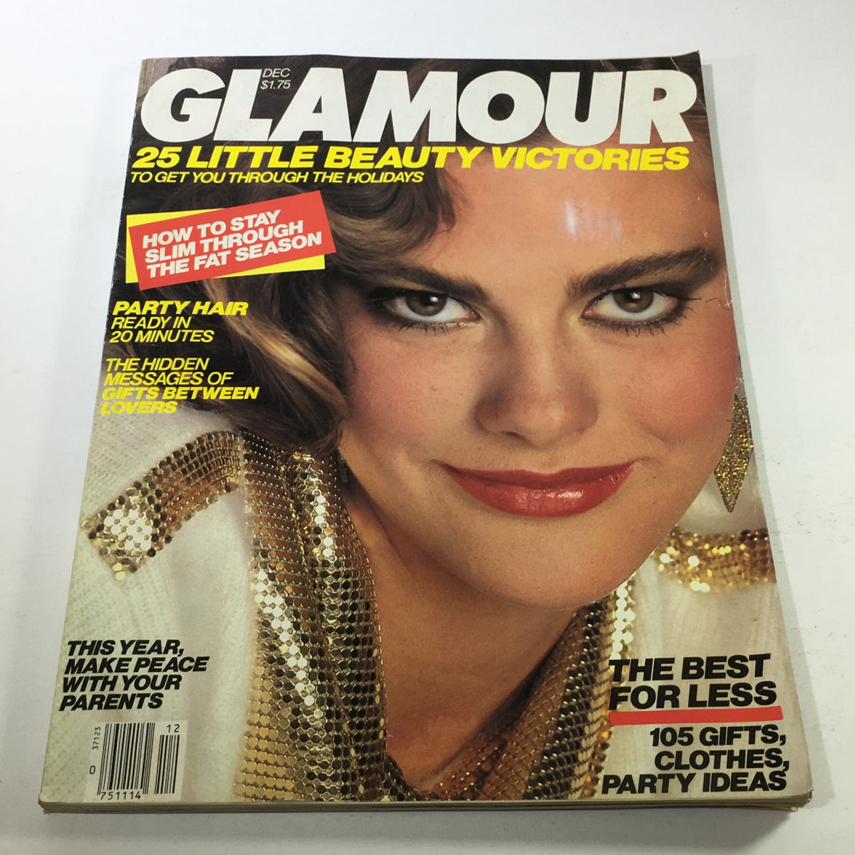 Vintage Glamour Magazine cover from December 1983 featuring a close-up of a confident model with glamorous makeup and fashion. The magazine highlights beauty tips and holiday ideas, making it a perfect collectible for vintage magazine enthusiasts.