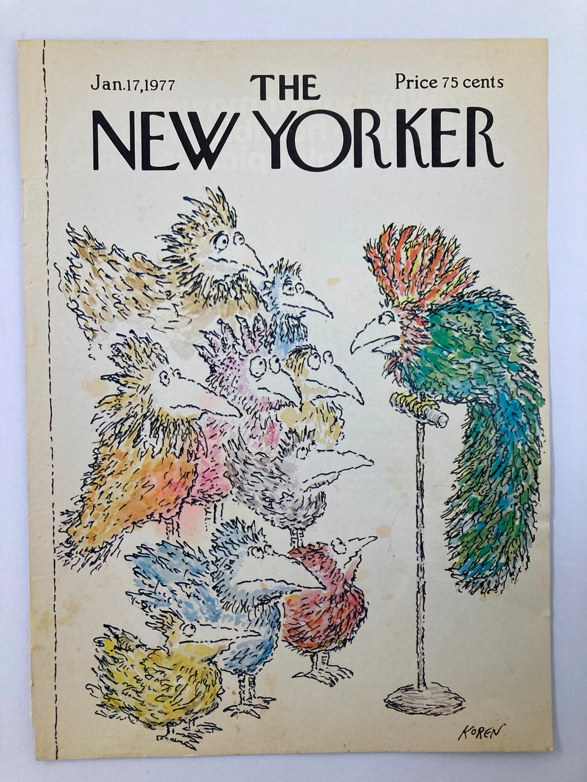Cover of The New Yorker from January 17, 1977, showcasing the artwork 'Feather Meeting' by E. Koren, illustrating a playful scene with vibrant, cartoon-like birds in discussion.