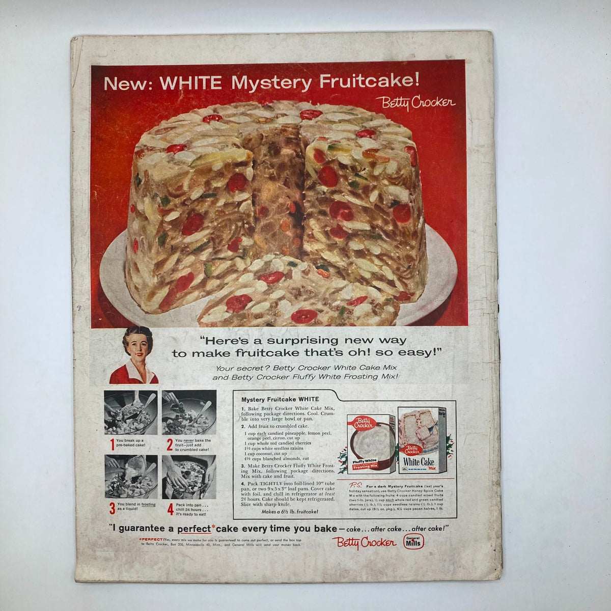 Back cover of Saturday Evening Post Magazine December 13 1958 featuring an advertisement for Betty Crocker's WHITE Mystery Fruitcake, illustrating the product and its preparation steps, highlighting vintage food marketing.