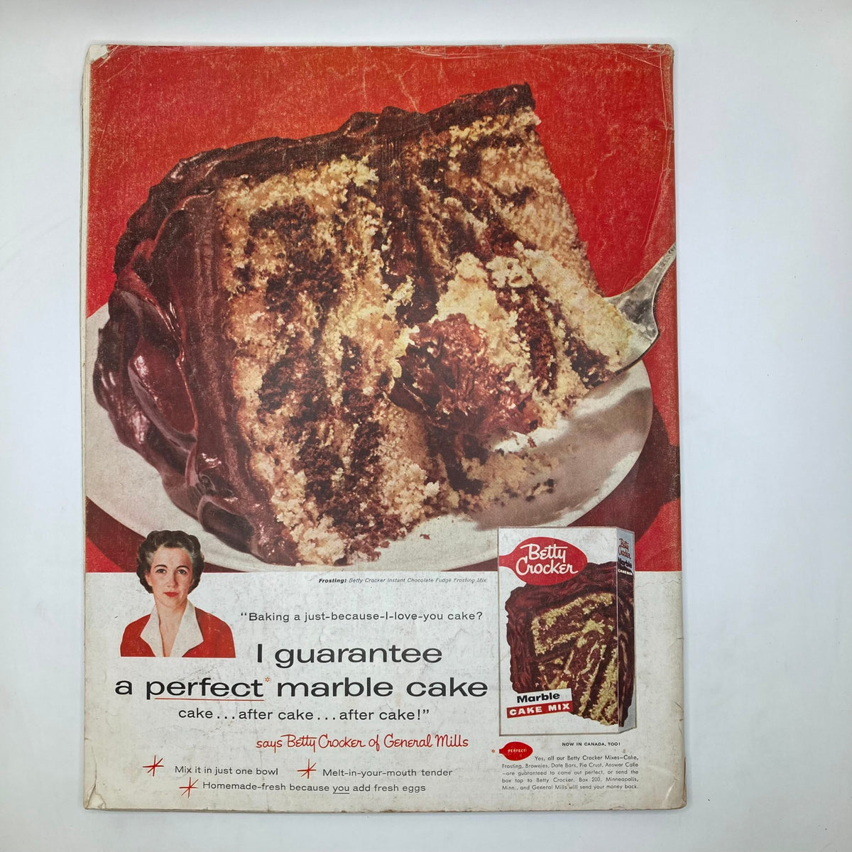 Cover of a vintage Betty Crocker advertisement for 'Marble Cake Mix,' featuring a picture of a beautifully sliced marble cake, promoting easy baking with a tagline about perfect cake.