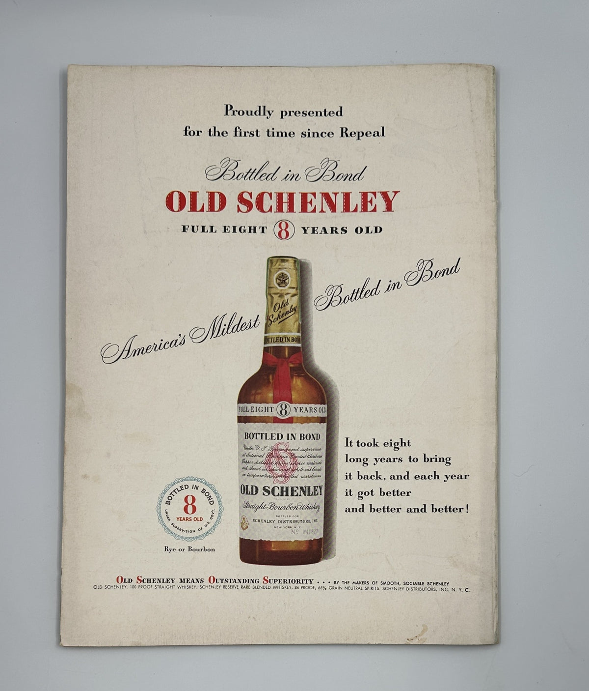 Vintage advertisement for Old Schenley whiskey, featured in Flair Magazine August 1950 College Review Issue, showcasing a bottle of Old Schenley, highlighting its quality as 'America's Mildest' and emphasizing its eight years of aging.
