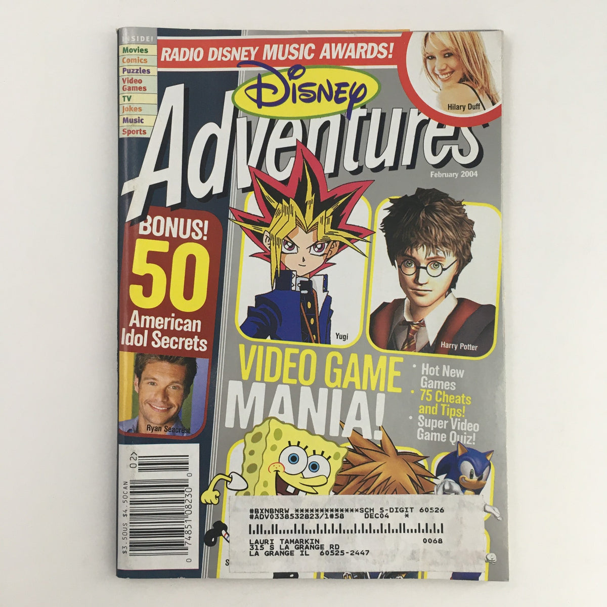 Disney Adventures Magazine February 2004 featuring Hilary Duff and Ryan Seacrest on the cover with a vibrant design, showcasing popular characters like Yugi and Harry Potter, and highlighting content focused on video games and American Idol secrets. Ideal for collectors and fans of early 2000s pop culture.