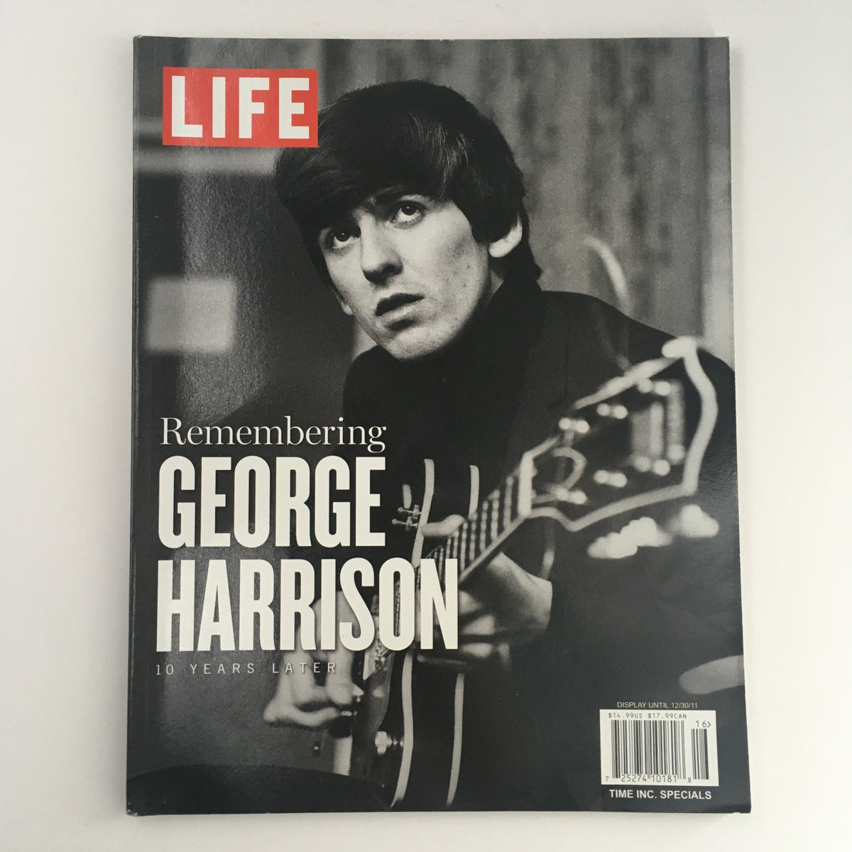 Cover of Life Magazine 2011 featuring the title 'Remembering George Harrison 10 Years Later', highlighting the legendary Beatle with an iconic image as he plays guitar.