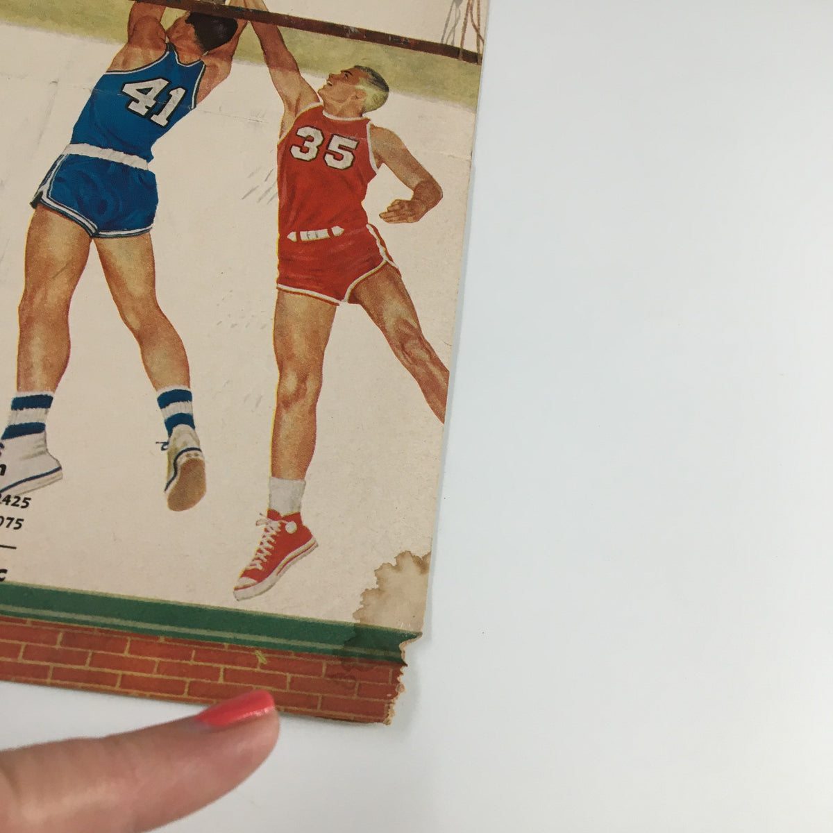 Close-up of the March 10, 1960 NCAA Basketball UCLA vs Stanford Official Program showing players in action.