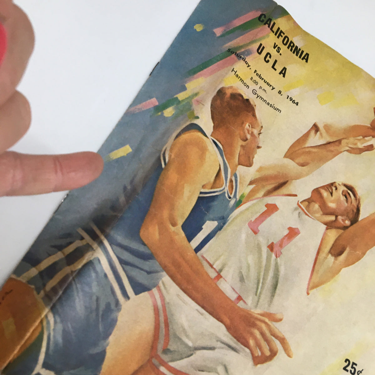 Cover of the February 8, 1964 NCAA Basketball Program featuring California vs UCLA, showcasing an illustration of two players in action during the game.