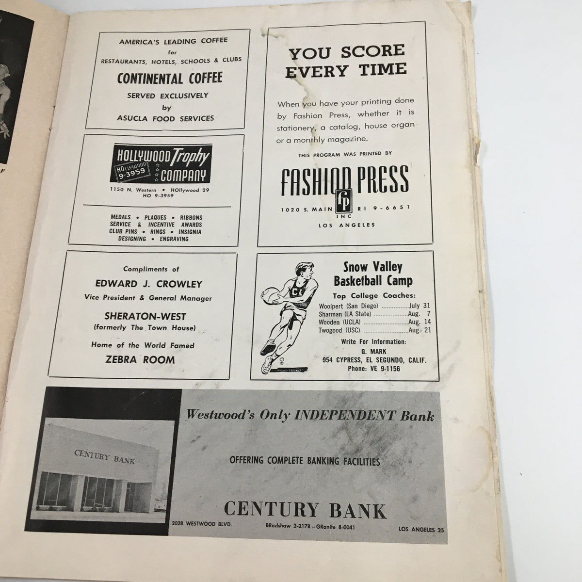 Advertisement page from the UCLA Bruins NCAA Basketball Program vs USC Trojans featuring local businesses and services relevant to fans from the 1963 era.