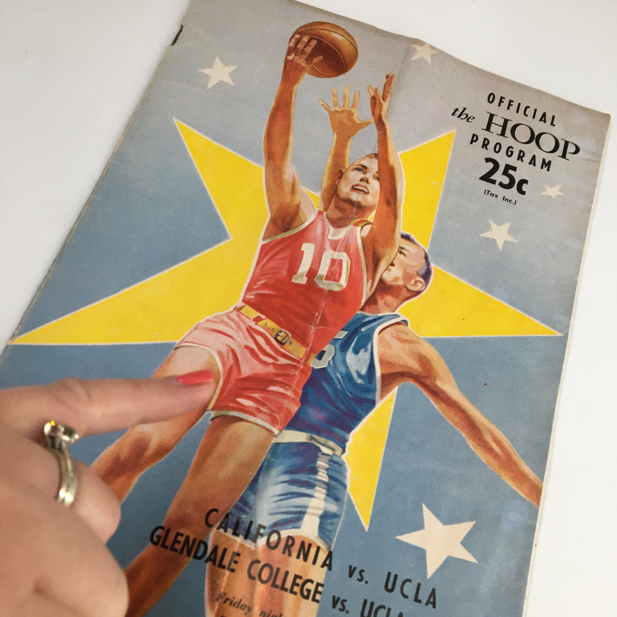 February 23 1962 NCAA Basketball Program with a close-up view highlighting the dynamic illustration of a basketball player in action, representing the historic game between California and UCLA.