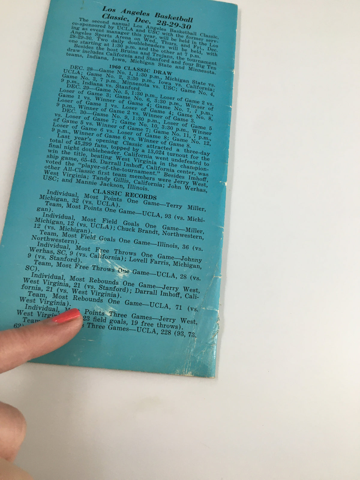 Detail view of the back cover of the 1960-1961 NCAA UCLA Bruins Varsity Basketball Schedule Program showcasing classic game records and statistics from the Los Angeles Basketball Classic.