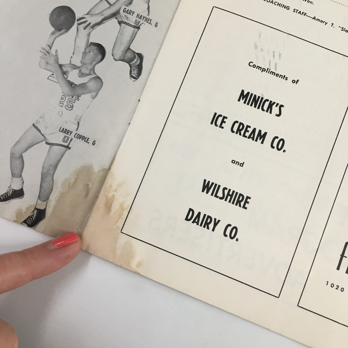 February 22, 1958 NCAA Basketball Oregon State vs UCLA Official Program featuring a page with player images and a water stain, promoting local businesses.