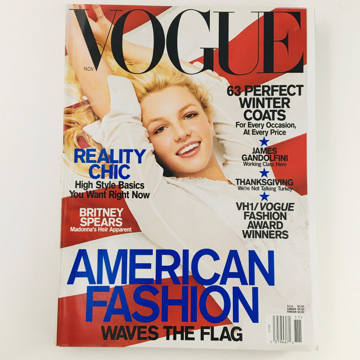 Vogue Magazine November 2001 cover featuring singer-songwriter Britney Spears, highlighting American fashion with a patriotic theme, and articles on chic lifestyle and winter coats.