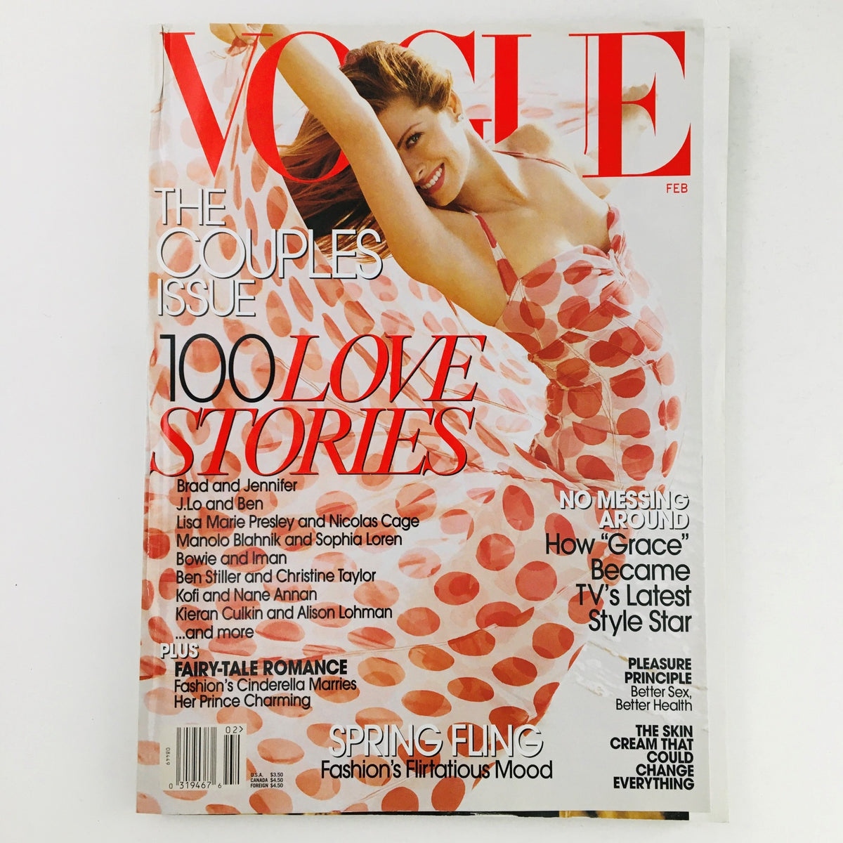 Cover of Vogue Magazine February 2003 featuring American actress Debra Messing, highlighting fashion and celebrity culture with the title 'The Couples Issue' and the feature '100 Love Stories'.