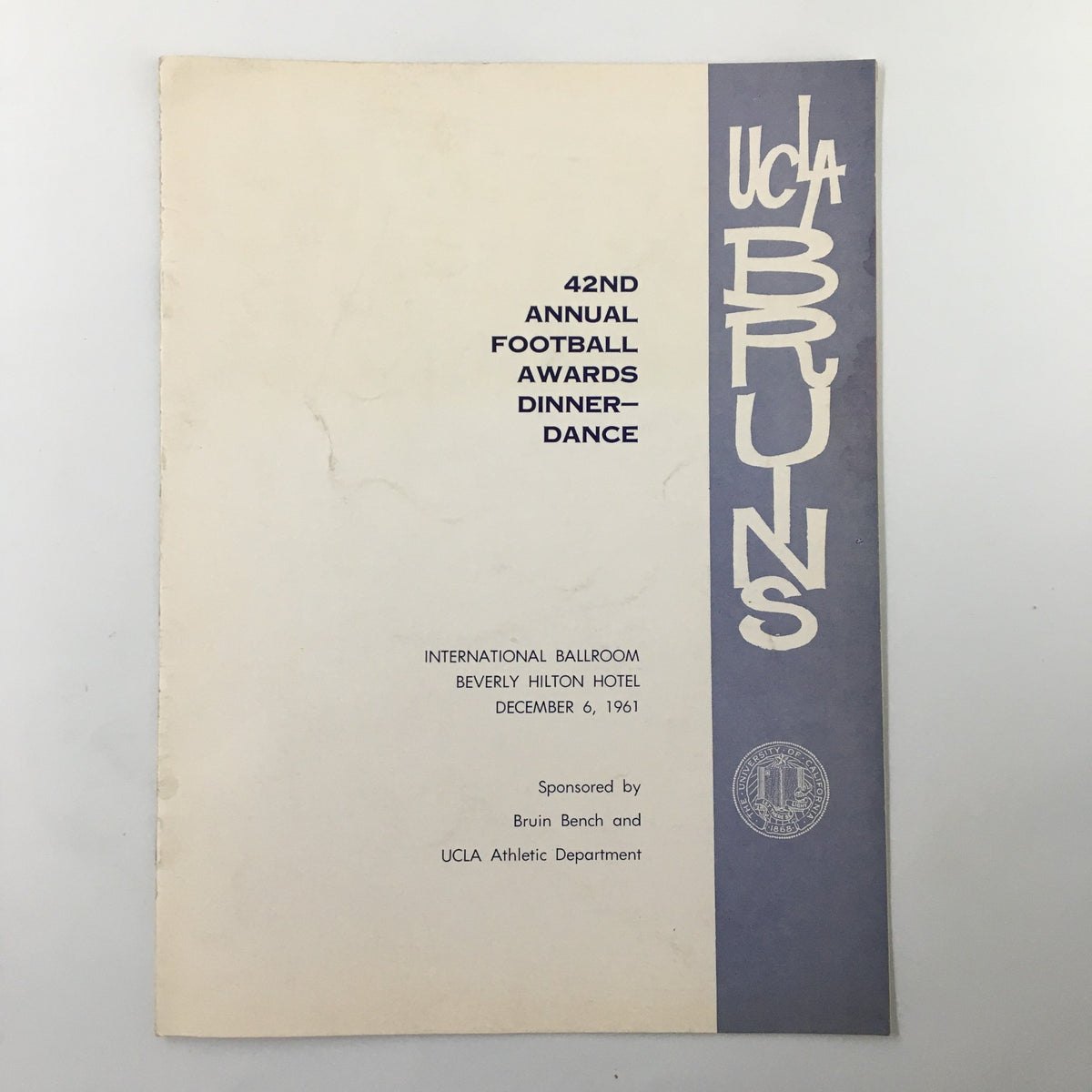 December 6, 1961 NCAA UCLA Bruins Annual Football Awards Dinner Dance Program cover, featuring the event details and iconic UCLA Bruins branding. This vintage program represents a significant moment in college football history, commemorating the 42nd Annual Football Awards Dinner Dance held at the Beverly Hilton Hotel.