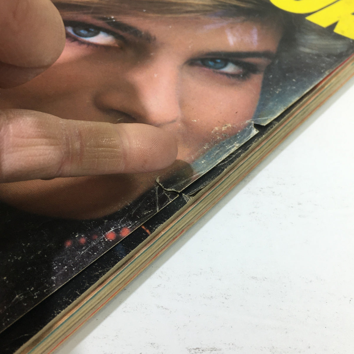 Close-up detail of the worn edges of the vintage Glamour Magazine September 1982, highlighting the magazine's history and character.