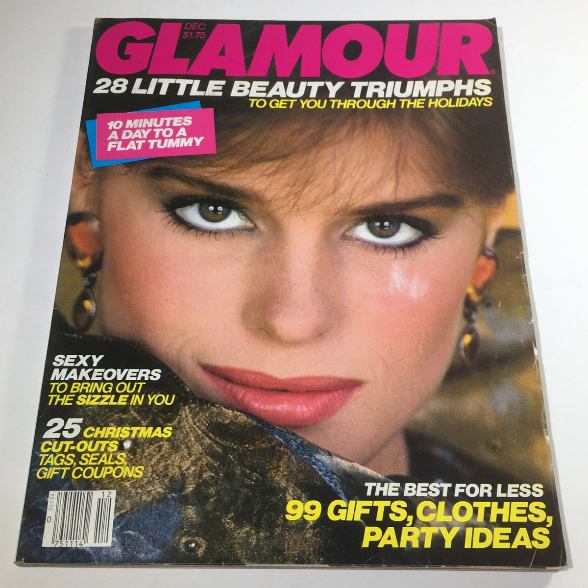 Vintage Glamour Magazine December 1982 featuring a close-up image of the model on the cover with striking makeup and earrings, showcasing fashion trends from the early 1980s.