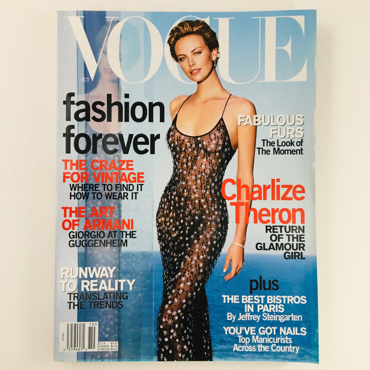 Vogue Magazine October 2000 cover featuring Charlize Theron in a glamorous gown, showcasing fashion trends from the early 2000s.