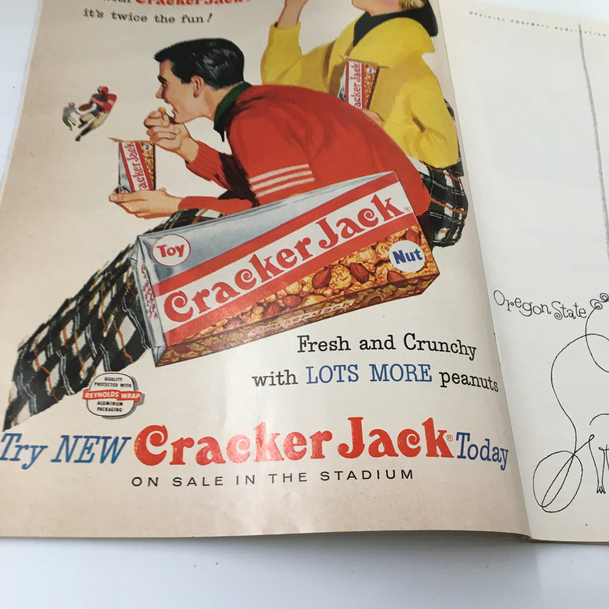 Advertisement page from the October 19, 1957 NCAA Football Program promoting Cracker Jack, adding a classic retro touch to the football memorabilia between Oregon State and UCLA.