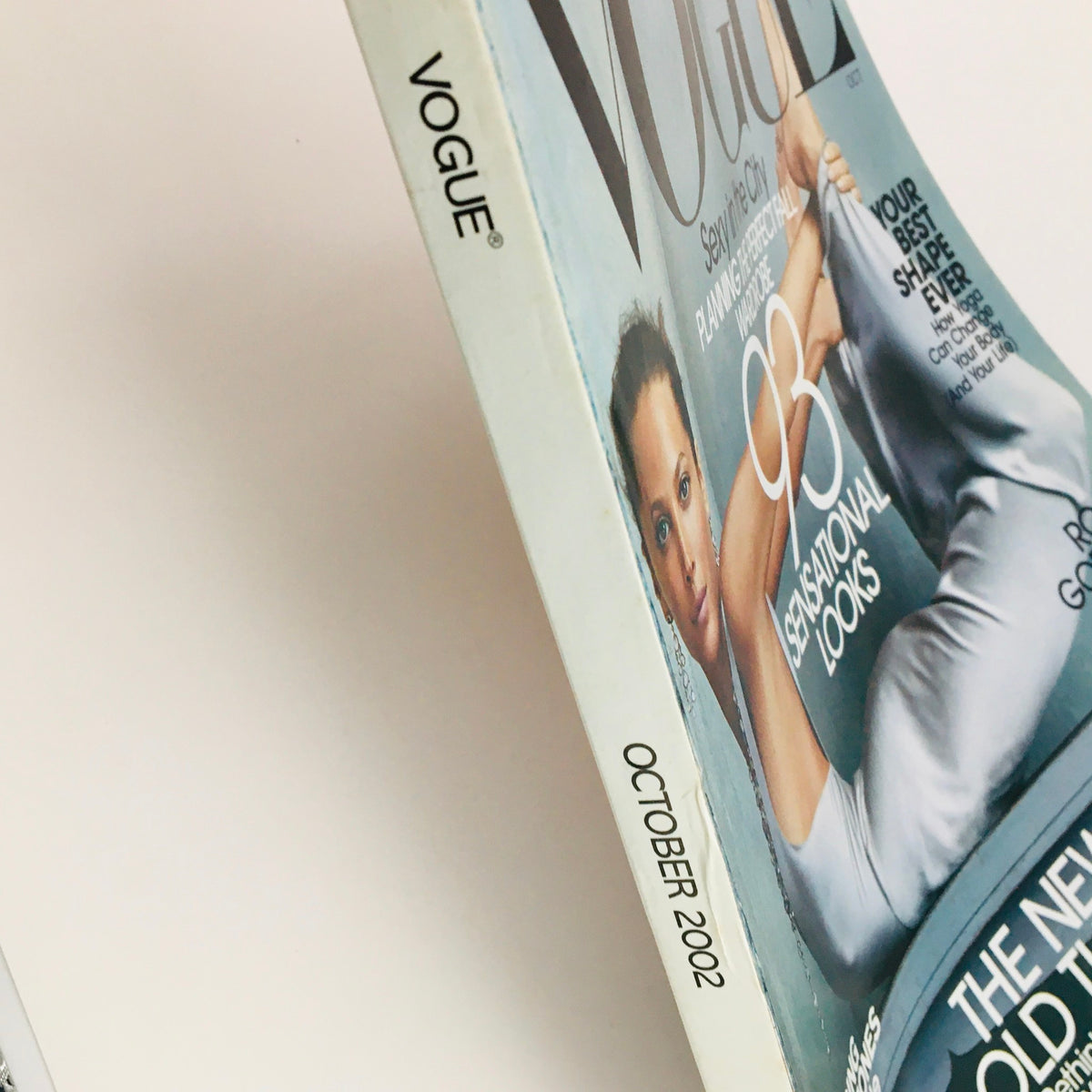 Side view of Vogue Magazine October 2002, highlighting the spine and cover design featuring Christy Turlington, ideal for showcasing in a magazine collection.
