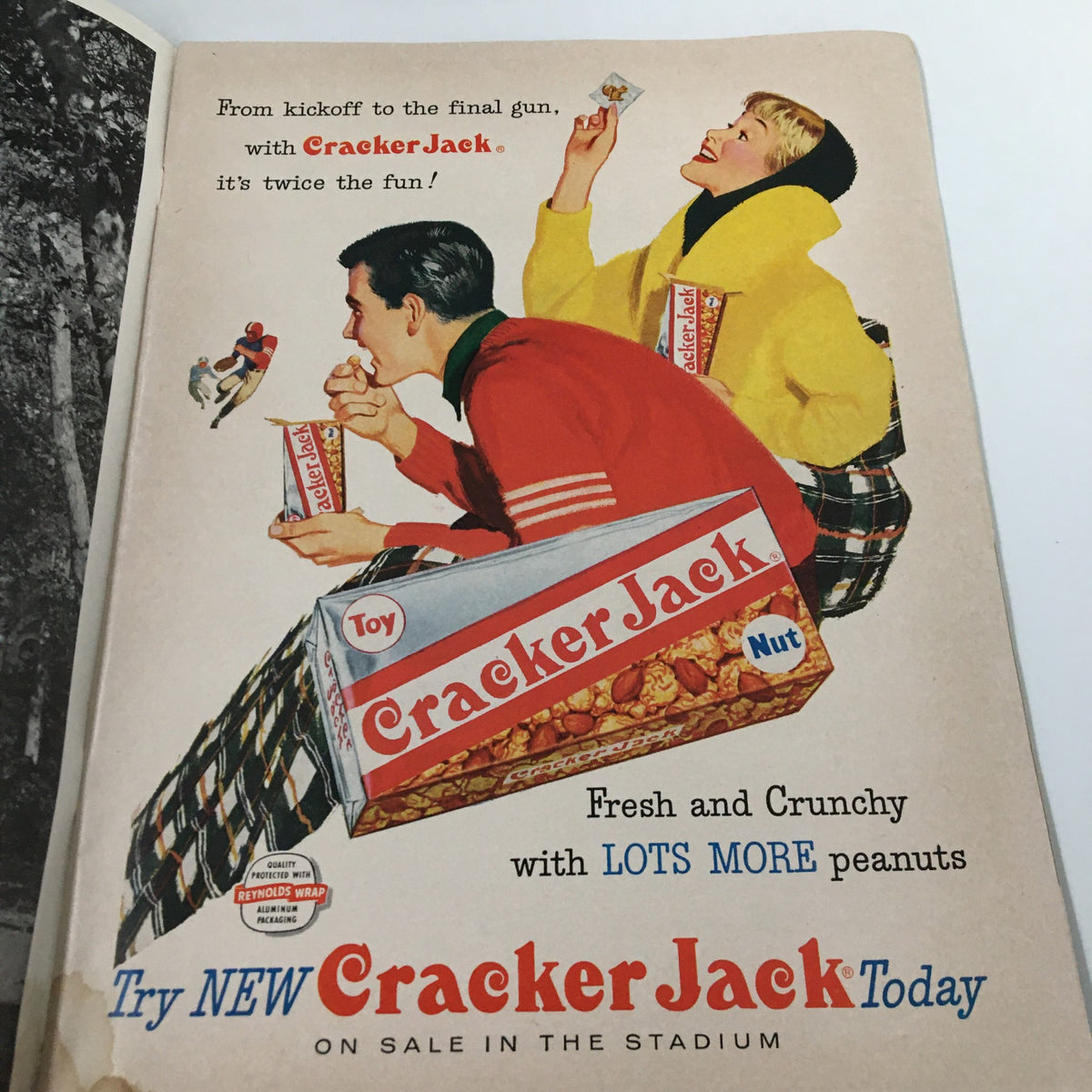 Vintage advertisement for Cracker Jack featuring a man and woman enjoying the snack, featured in the November 23 1957 NCAA Football SC Trojans vs UCLA Bruins Pigskin Review.