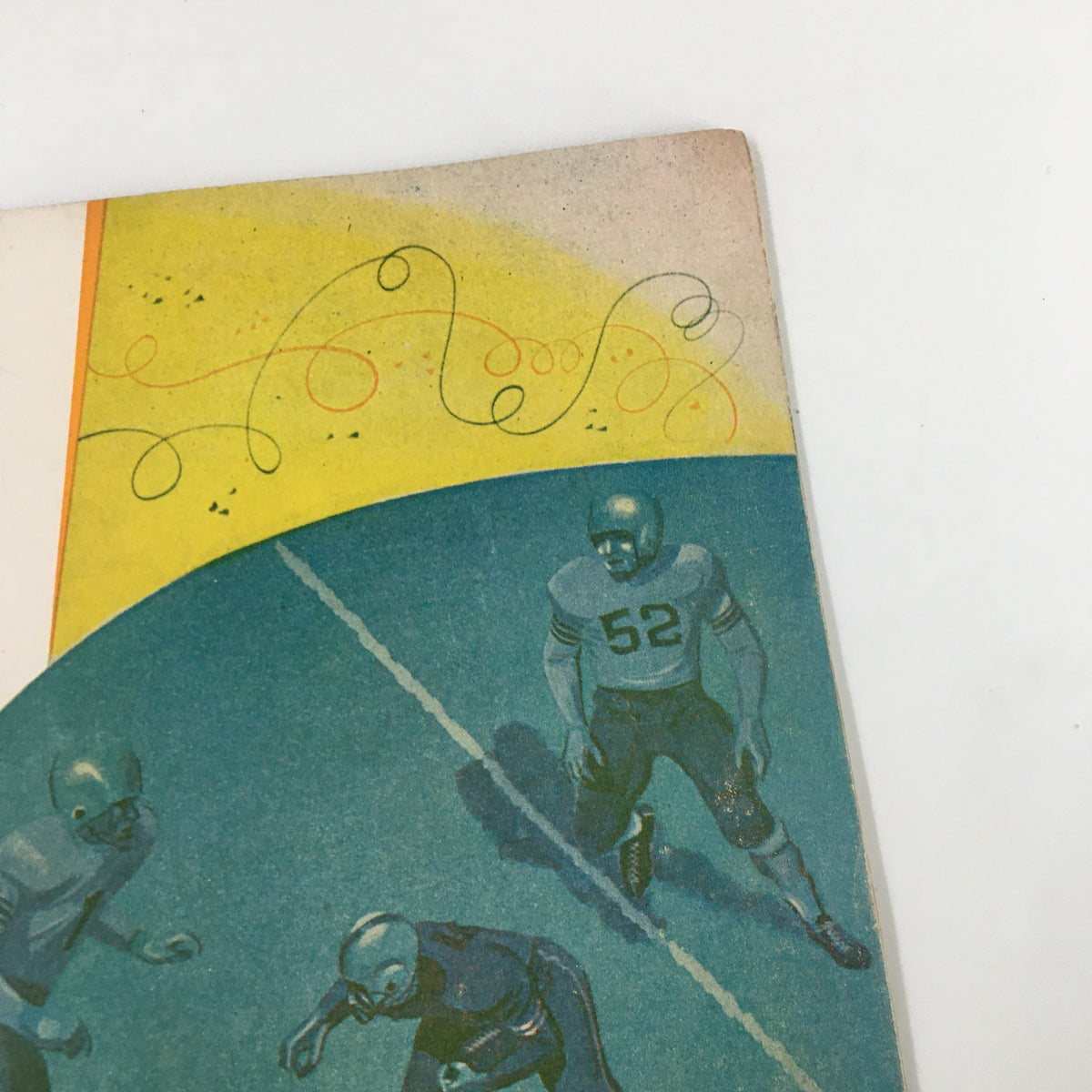 Another angle of the cover of November 6 1954 NCAA Football Oregon vs UCLA The Goal Post Official Program, highlighting the action-packed illustration of football plays.