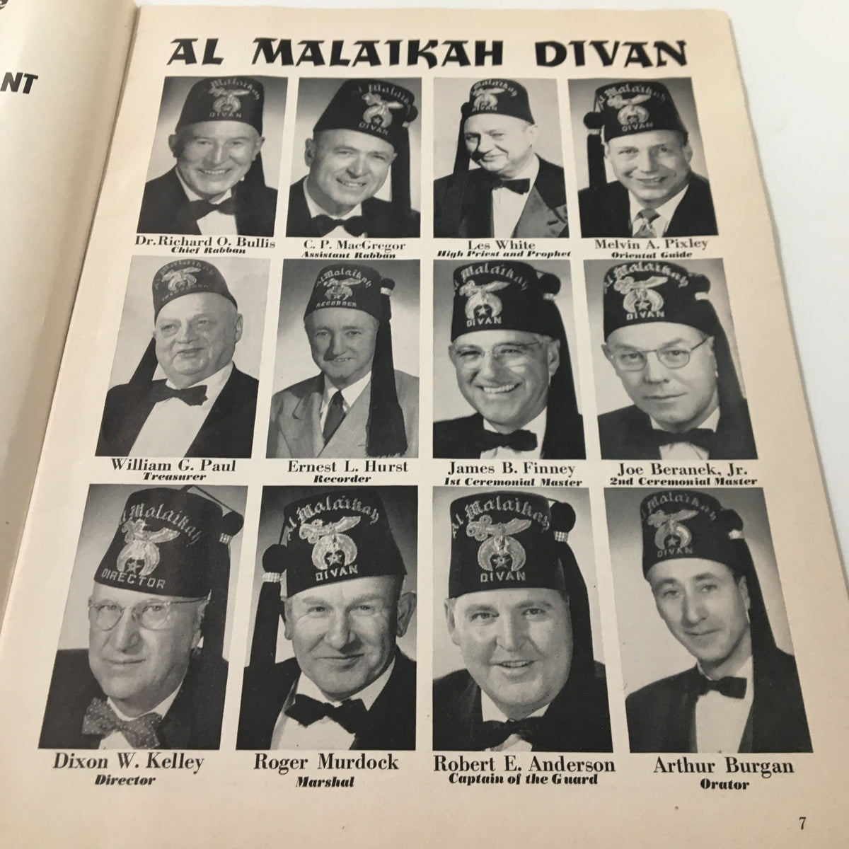 Group photo of the Al Malaikah Divan members featured in the 1956 NCAA 5th Annual Shrine Football Game and Pageant Souvenir Program, each wearing ceremonial fezzes.