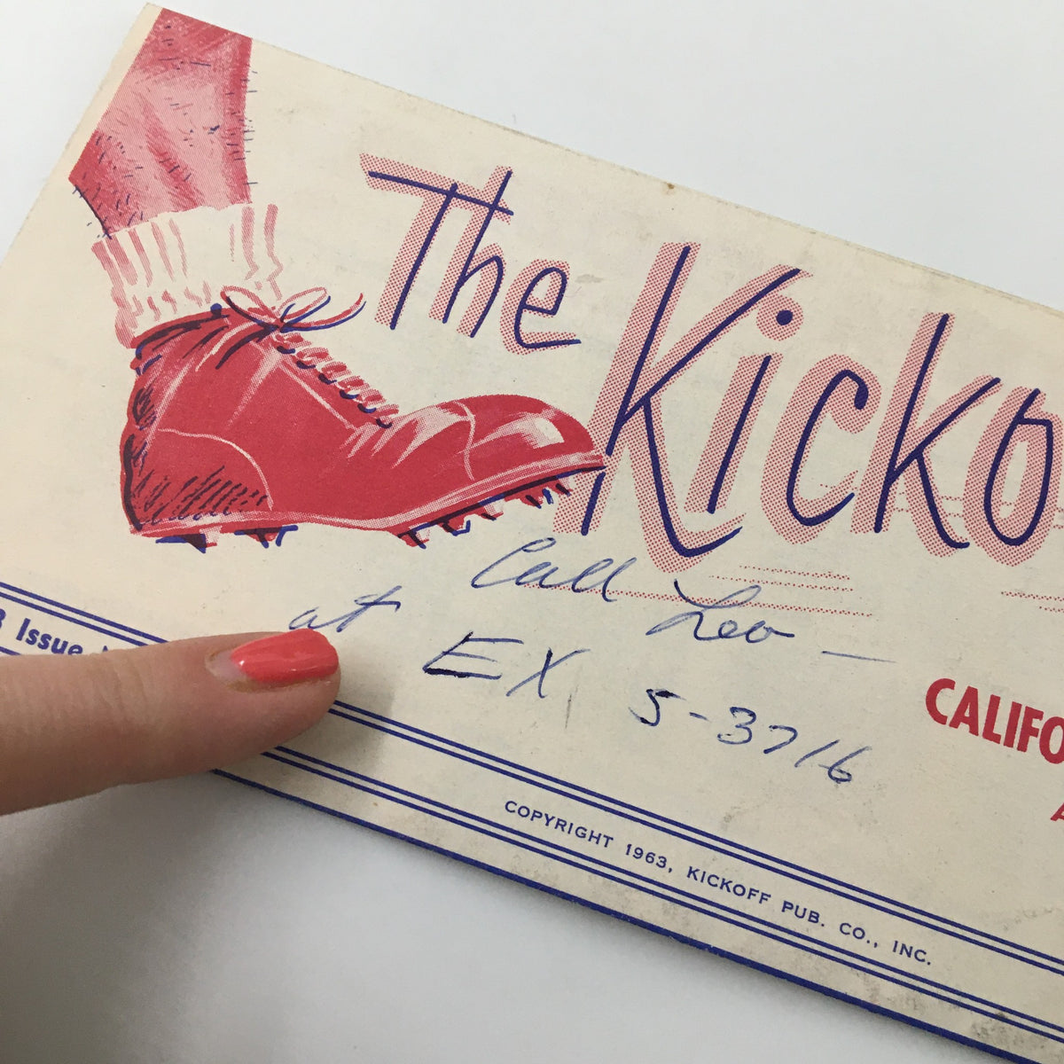 Close-up view of the December 2 1963 NCAA Football USC Trojan Huddle The Kickoff Program showcasing the red football shoe and handwritten details.
