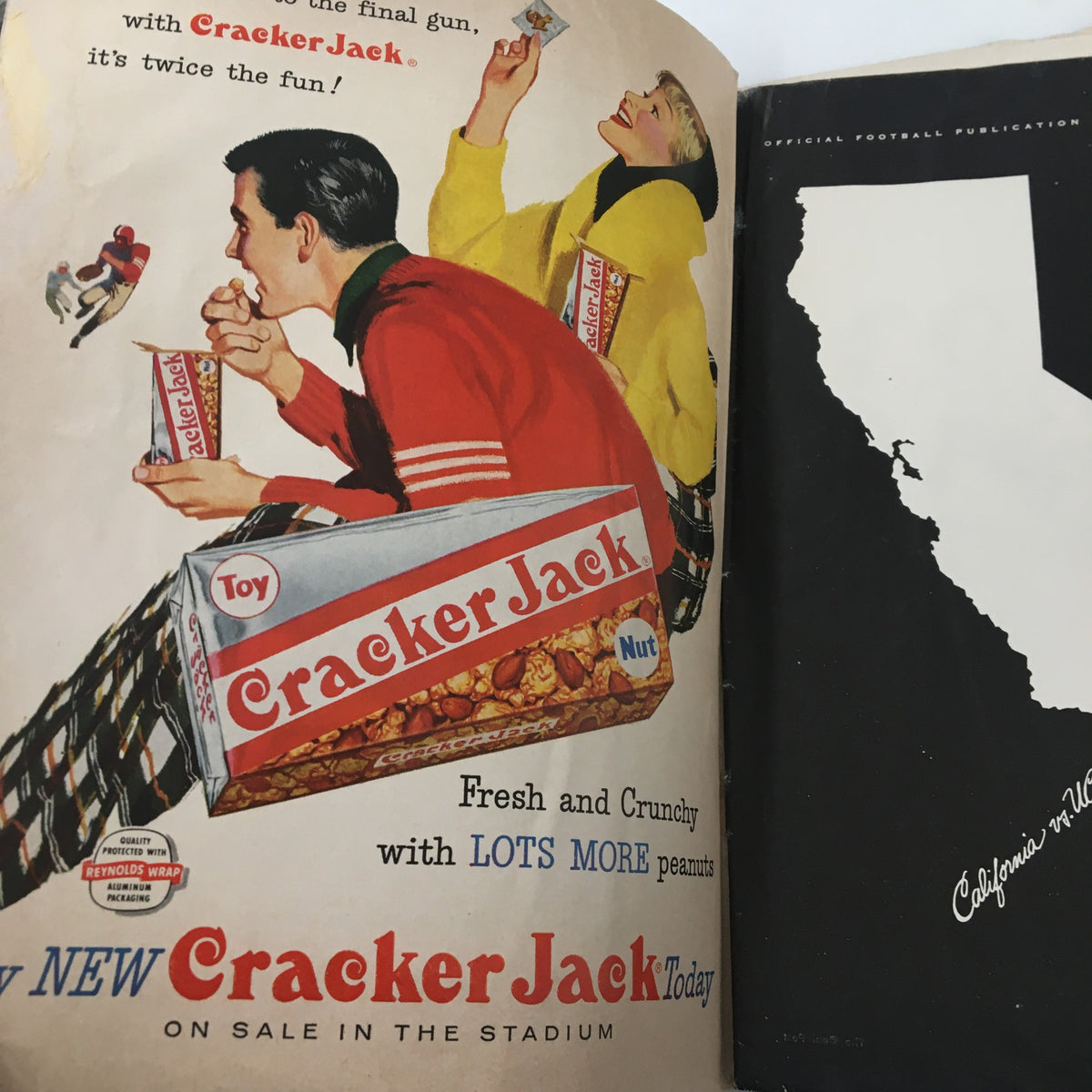 Advertisement in the official program for the November 2, 1957 NCAA Football game showcasing Cracker Jack snacks, promoting fun at the game.