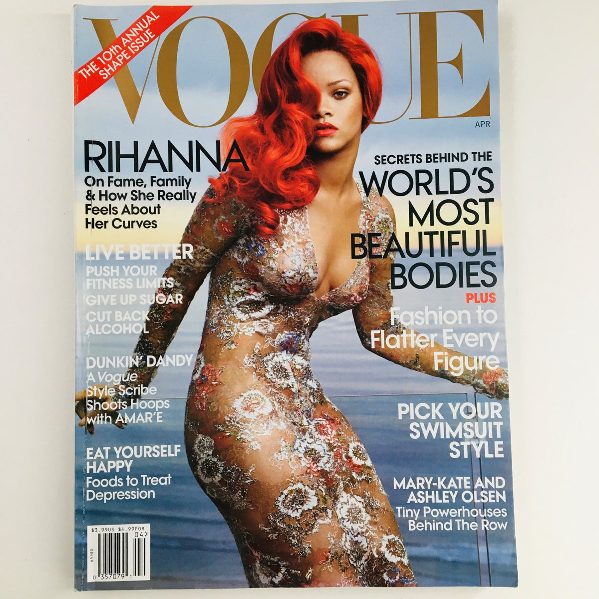 Vogue Magazine April 2011 featuring Barbadian singer Rihanna on the cover, showcasing her stunning look in a floral dress. This collectible vintage magazine captures Rihanna's influence on music and fashion during a pivotal moment in her career.