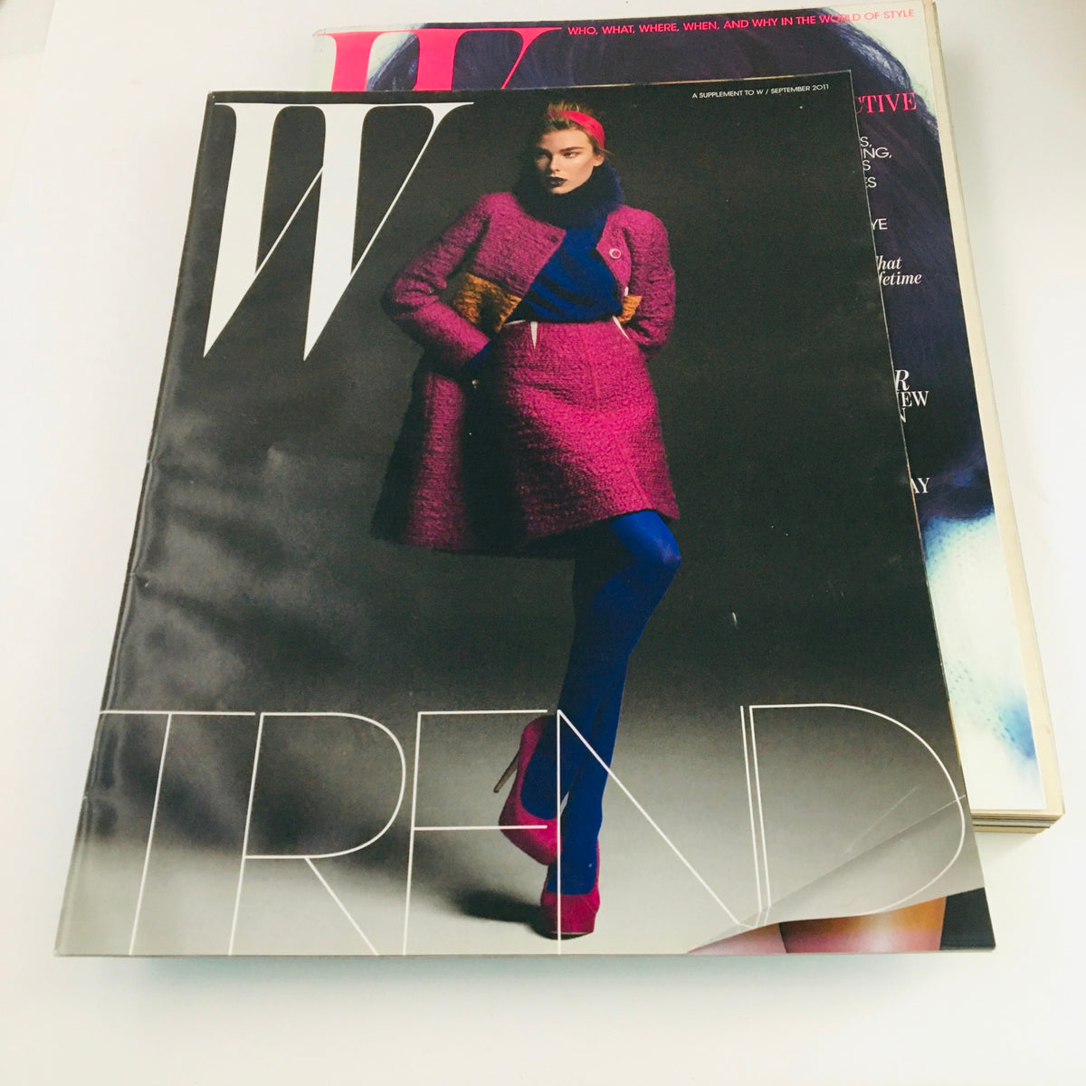 W Magazine September 2011 with a focus on the fashion theme, presenting a model in a stylish pink ensemble, complementing the overall magazine's trendsetting essence.