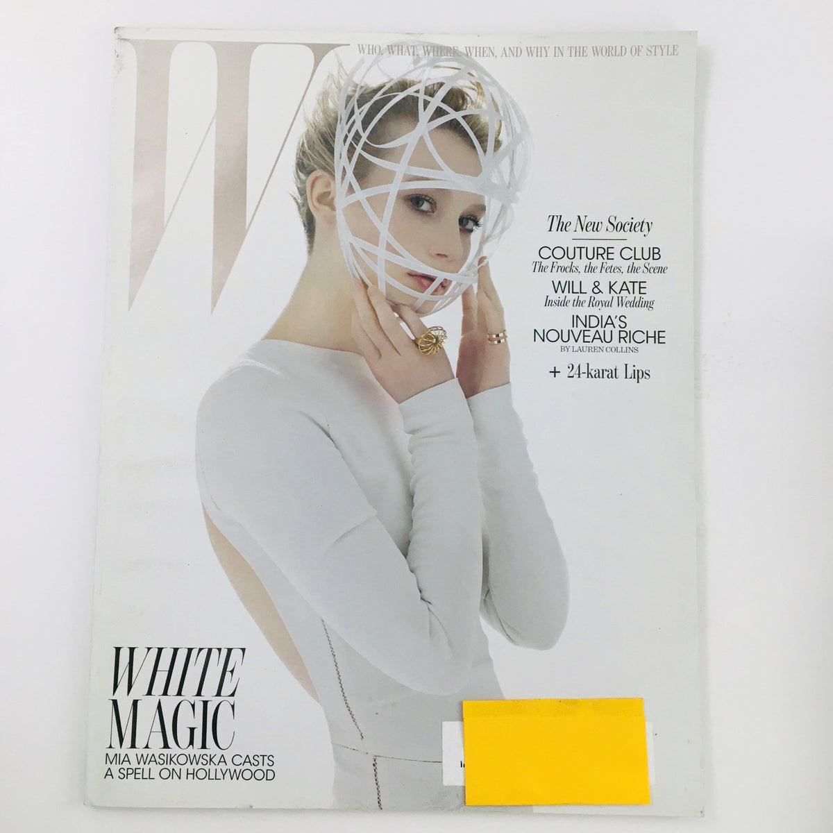 W Magazine April 2011 cover featuring Australian actress Mia Wasikowska in a stunning white outfit with a unique headpiece titled 'White Magic'.